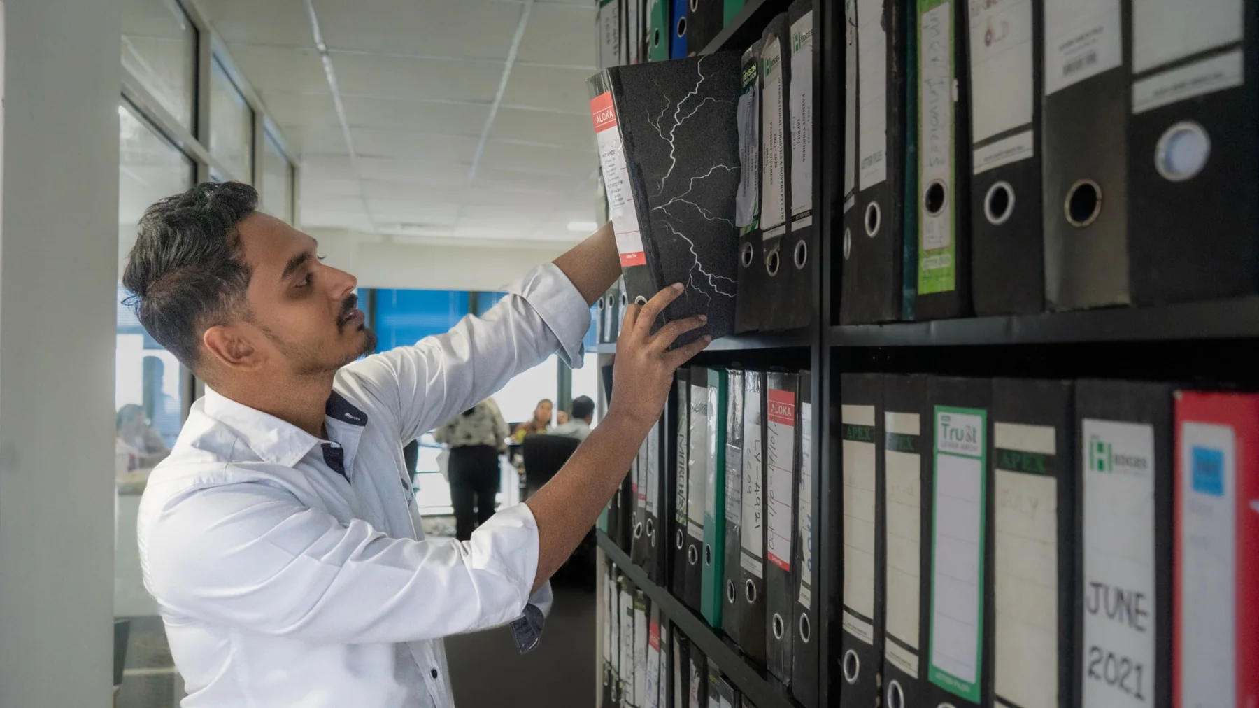 An ILM Holdings team member pulling a shipping file from the records room