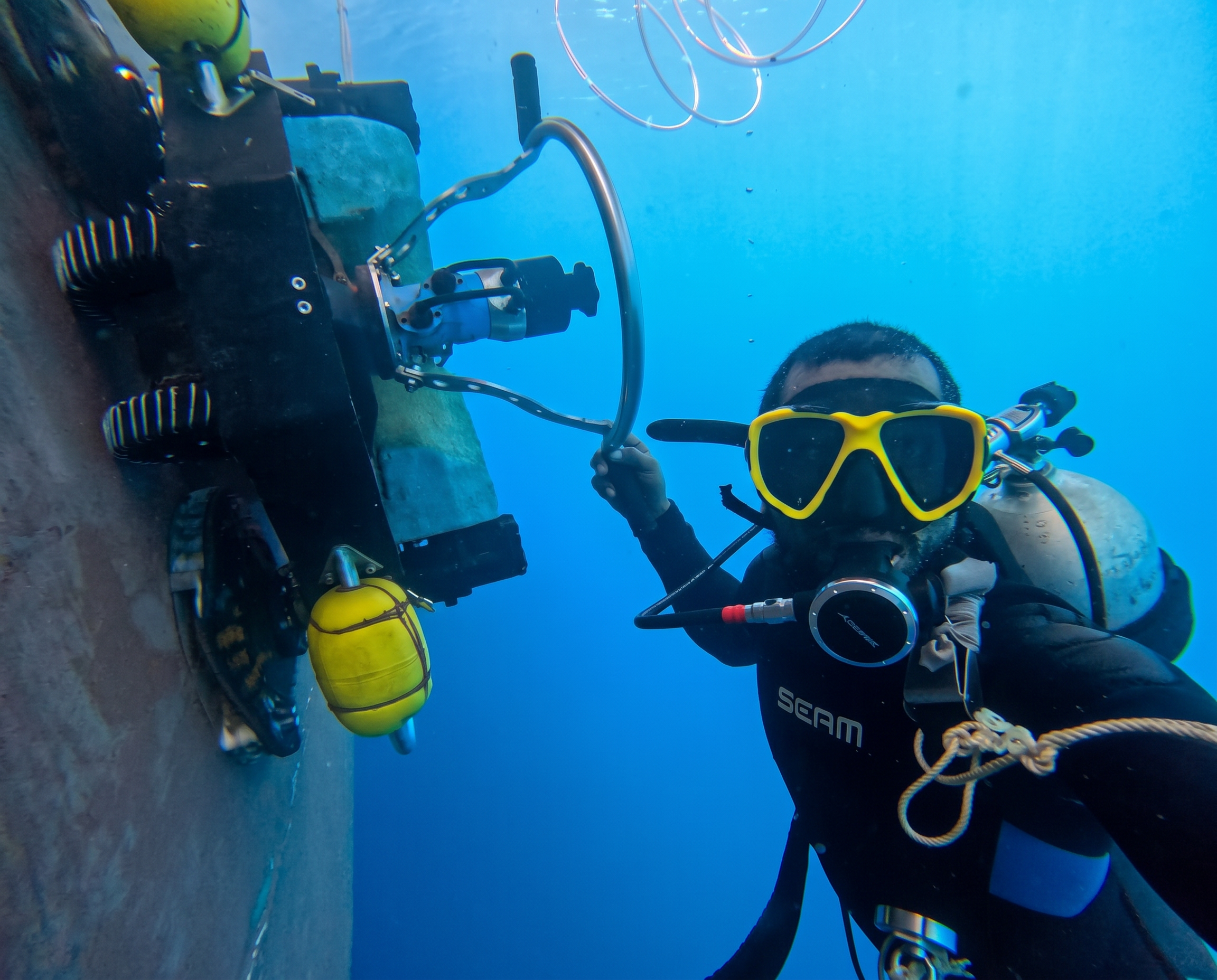 Commercial diver carrying out an underwater hull inspection